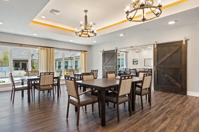 Dining area with wooden tables and bright decor