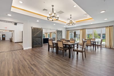 Bright common area with dining tables and chairs