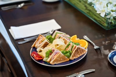 A beautifully arranged plate of sandwiches and snacks