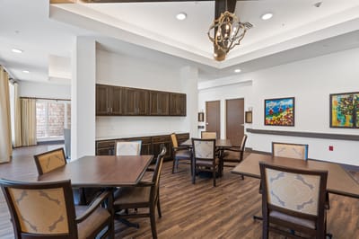 Common area with tables and chairs in an interior setting