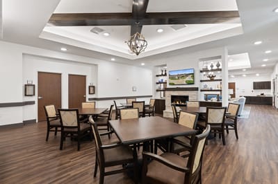 Bright and spacious common area with tables and chairs