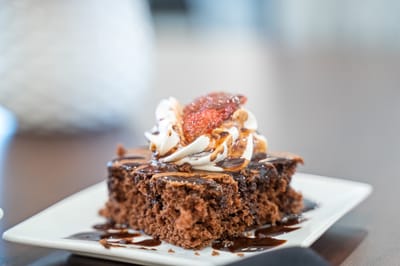 Delicious chocolate cake with whipped cream and strawberry