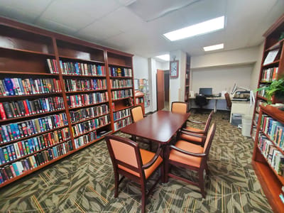 Interior of a library with bookshelves and a table