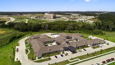 Aerial view of a senior living facility with landscaped grounds