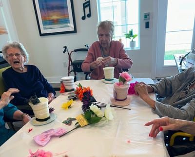 Residents engaging in a craft activity at a table