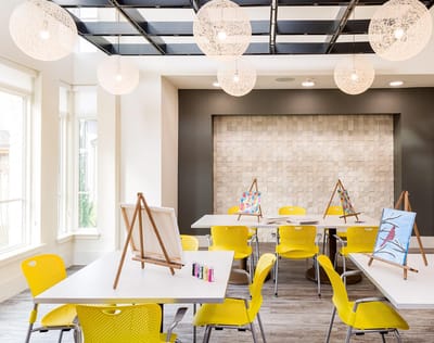 Colorful activity room with easels and bright chairs