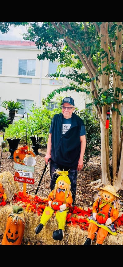 Resident enjoying a festive pumpkin patch setup outdoors
