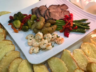 A plate of gourmet food including meat and vegetables
