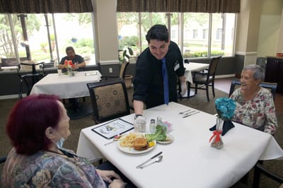 Residents enjoying a meal in the dining room