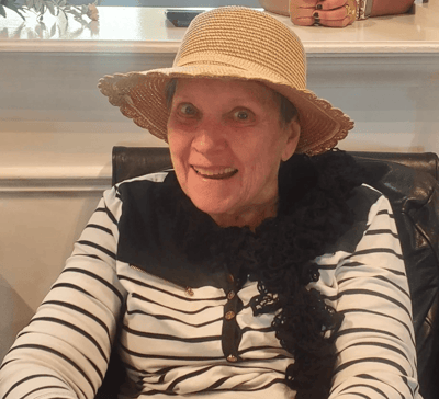 Resident smiling in a cozy common area