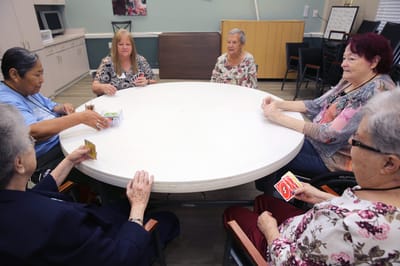 Residents playing cards in a common area
