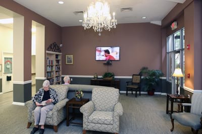 Residents relaxing in a cozy common area with seating