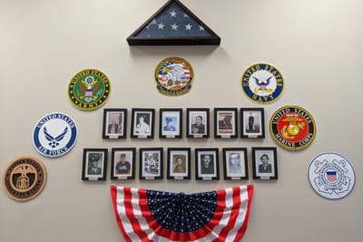 Gallery wall honoring military veterans in the facility