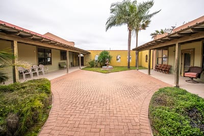 Outdoor courtyard area with seating and greenery