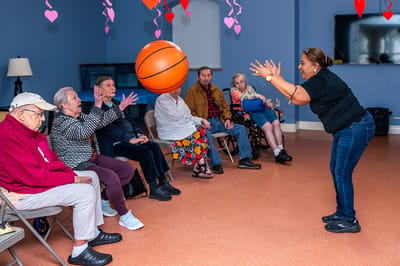 Residents participating in a basketball toss activity