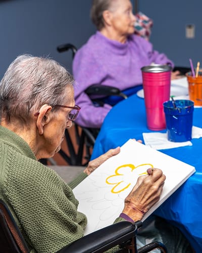 Residents engaged in a painting activity