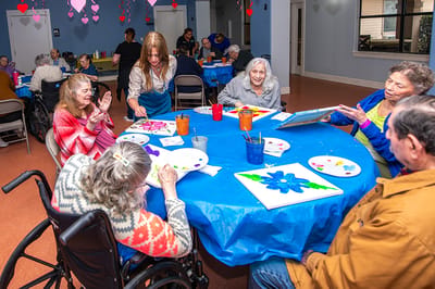 Residents engaged in a painting activity in a common area