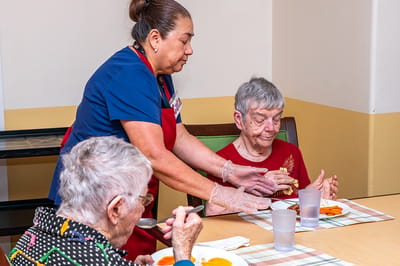 Staff assisting residents during mealtime