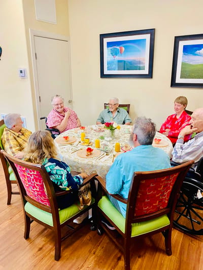 Residents enjoying a meal together at a round table