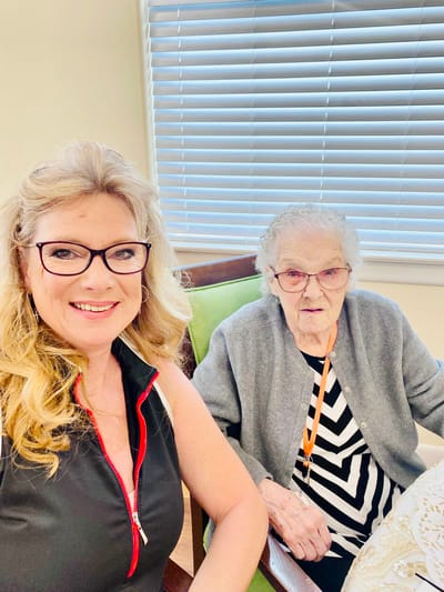 A staff member with a resident in a common area