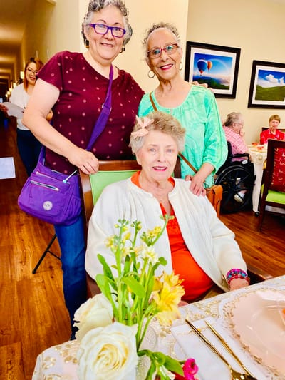 Residents enjoying a meal in a lively dining room