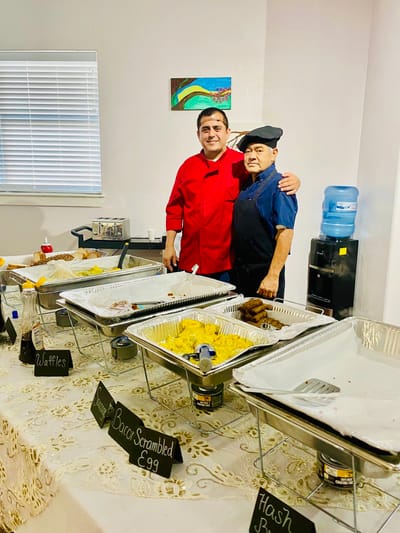 Staff serving breakfast in a dining area