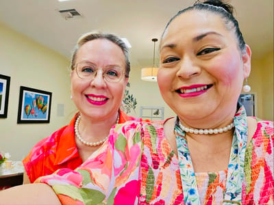 Two staff members smiling for a selfie in the facility