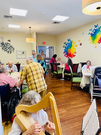 Residents enjoying a group activity in a colorful common area