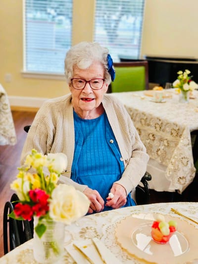 A resident enjoying time in a decorated dining area