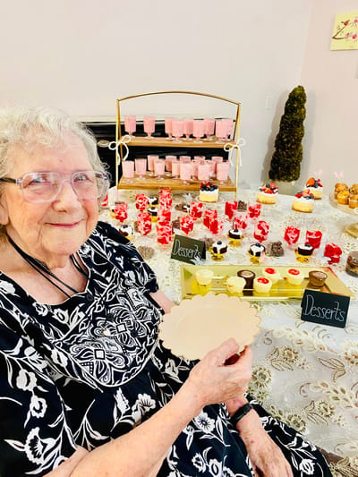 Resident enjoying desserts at a celebration table