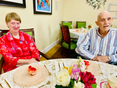 Residents enjoying a meal together at a dining table