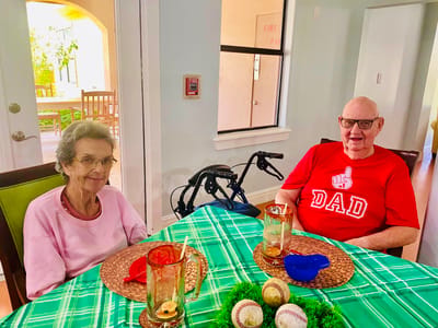 Two residents enjoying conversation at a table