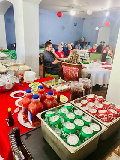 Residents enjoying a meal with drinks during a social event