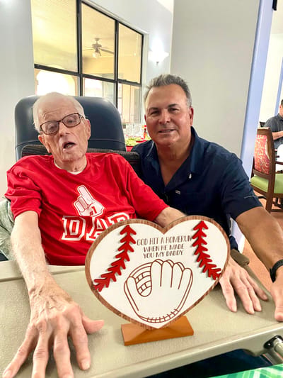 Resident and staff member celebrating with a handmade sign