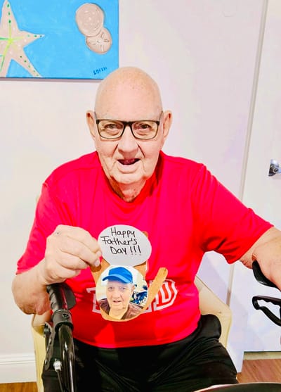A resident celebrating Father's Day with a photo