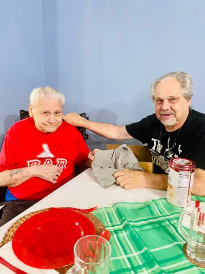 Two elderly men sitting at a table