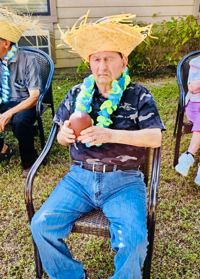 Residents enjoying an outdoor activity with festive hats