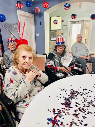 Residents celebrating with festive hats indoors
