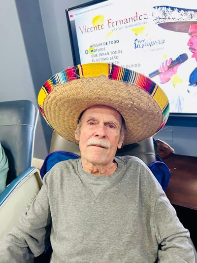 Resident wearing a sombrero in a lively common area