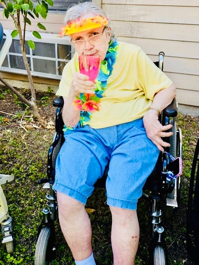 Resident enjoying a colorful drink outside