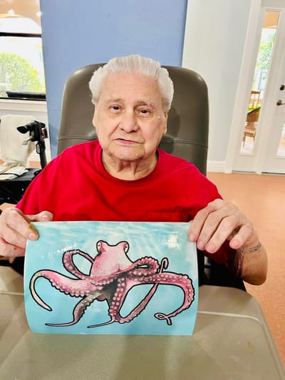 A resident showcasing their artwork of an octopus