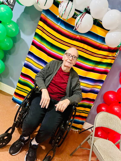 Resident in a wheelchair at a festive event