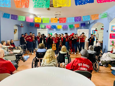 Residents enjoying a performance in a common area