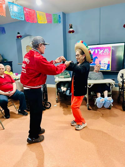 Residents enjoying a dance activity with staff
