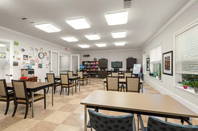 Bright activity room with tables and chairs