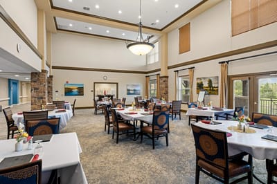 Bright and inviting dining room with tables set for meals