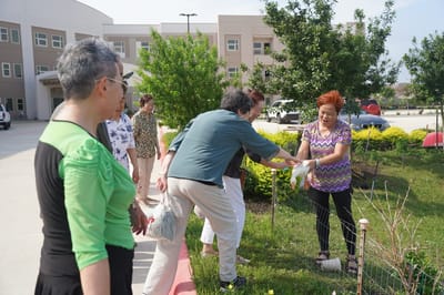 Residents gardening together in outdoor space