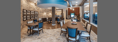Bright common area with dining tables and seating