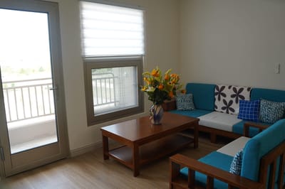 Cozy sitting area with bright flowers and comfortable seating