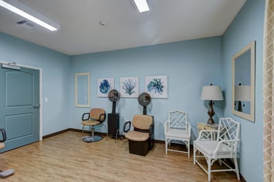 Interior lounge area with salon chairs and artwork